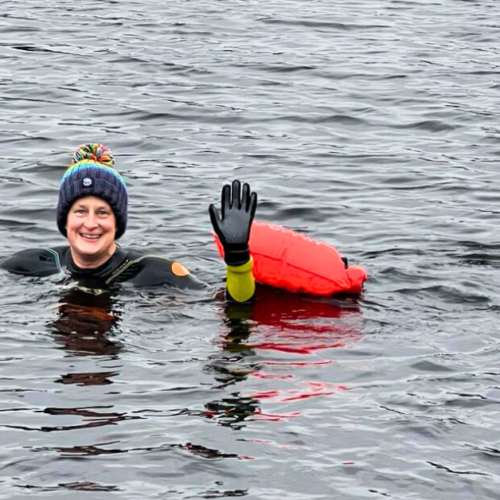 lady swimmer in lake, waving